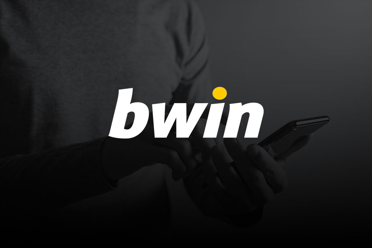 Imagem grfica com logo da bwin em tons de branco e amarelo sobrepondo foto de algum usando telemvel representando um apostador.